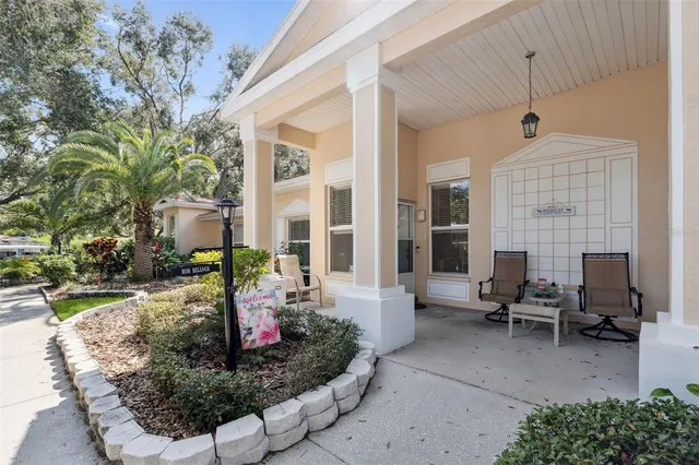 a view of a patio with couches table and chairs and potted plants