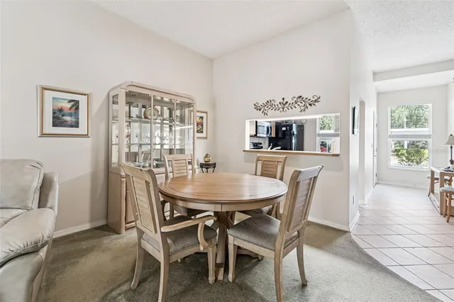 a dining room with furniture and window