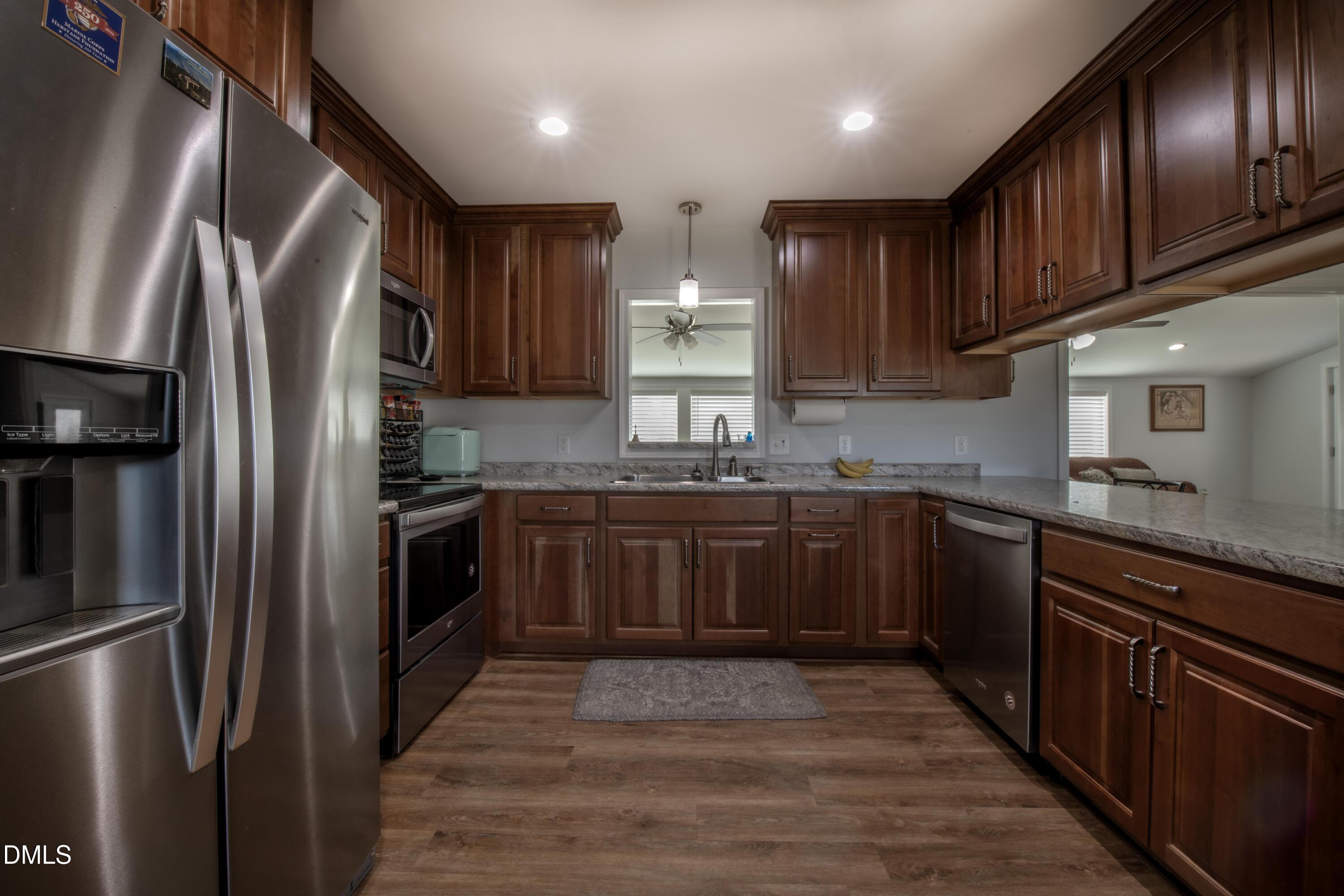 130 Hardy Road Wendell, NC 27591 - Photo 12 of 34 a kitchen with granite countertop stainless steel appliances and wooden cabinets