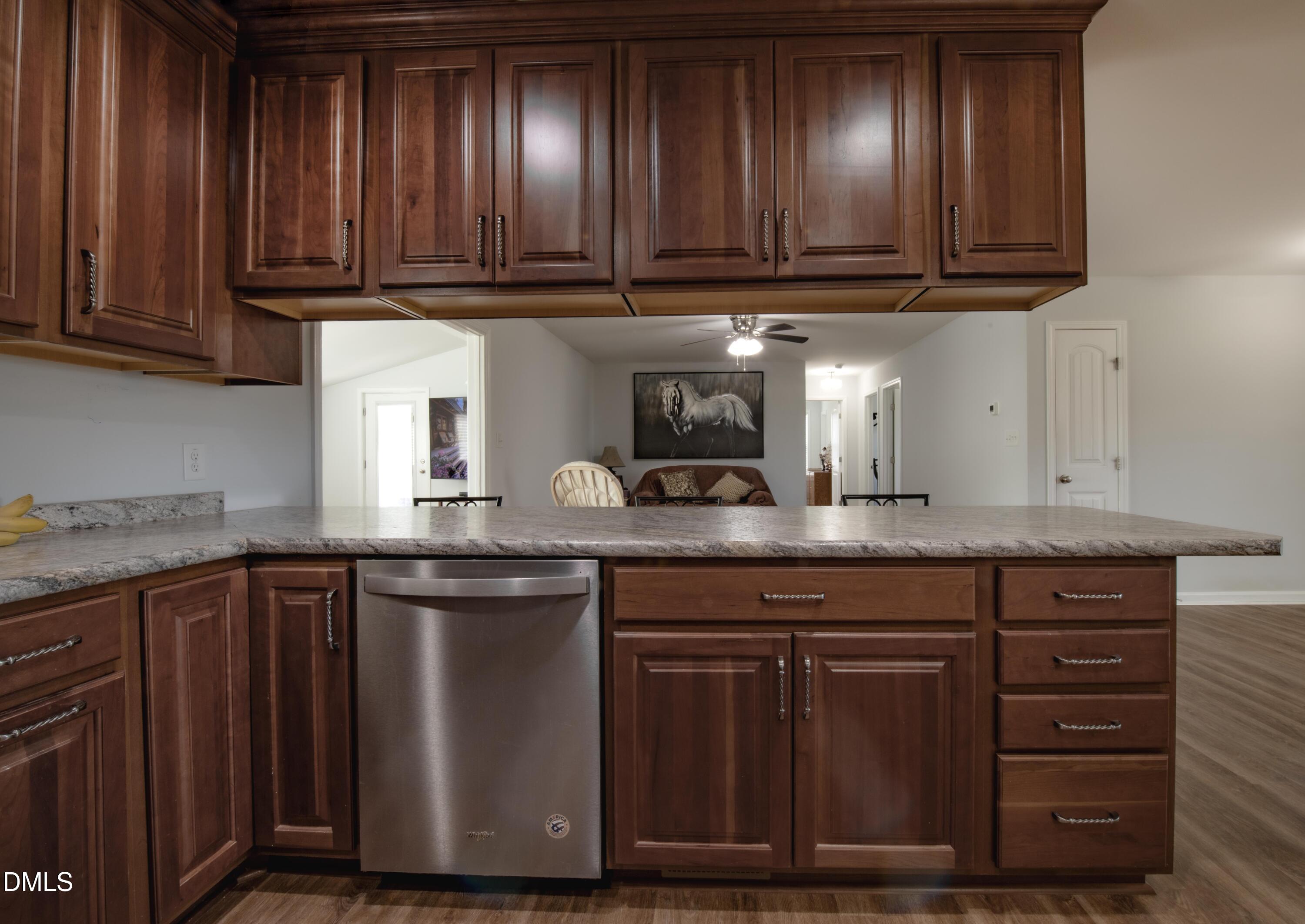130 Hardy Road Wendell, NC 27591 - Photo 14 of 34 a kitchen with granite countertop wooden cabinets and a sink