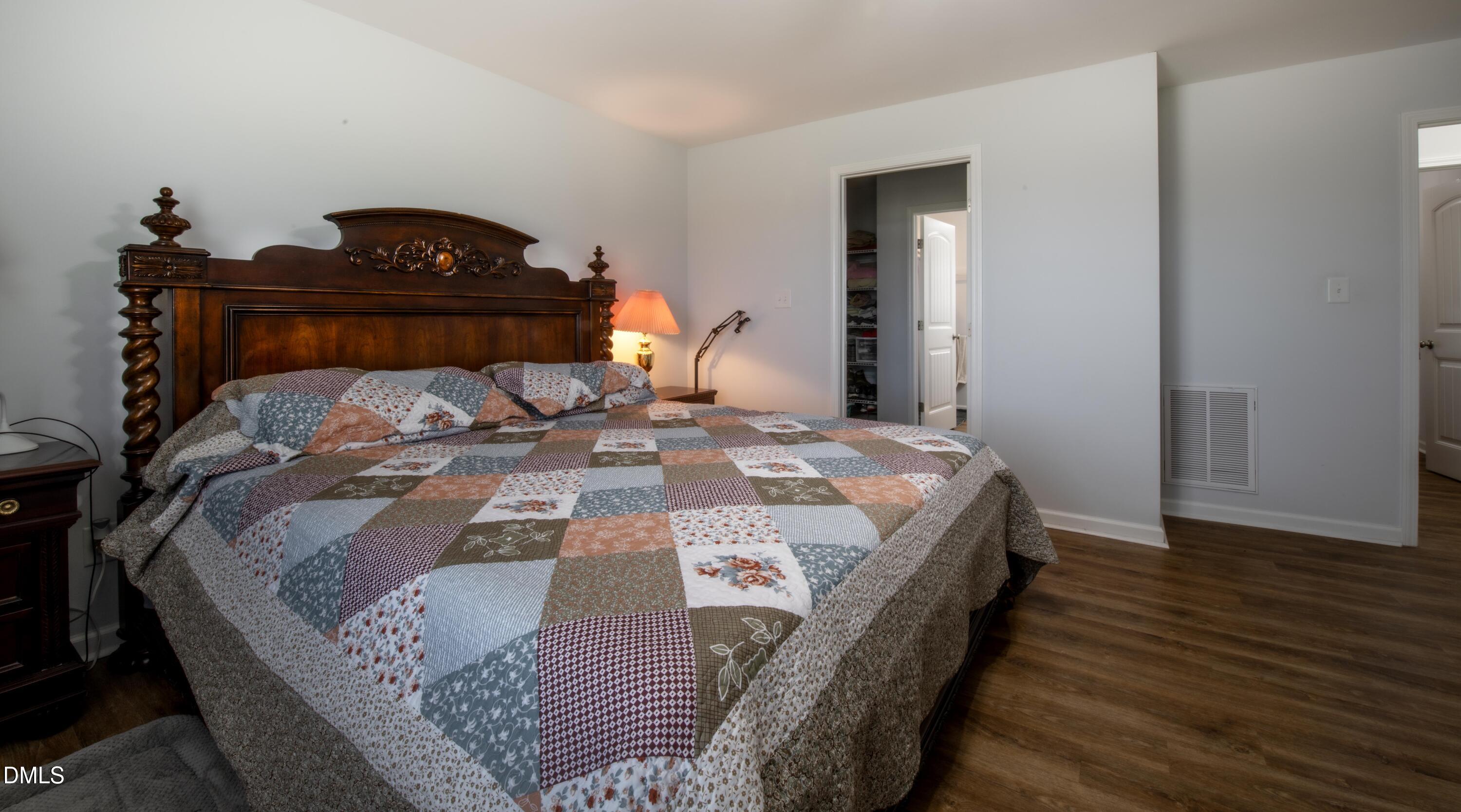 130 Hardy Road Wendell, NC 27591 - Photo 17 of 34 a bed sitting in a bedroom and wooden floor