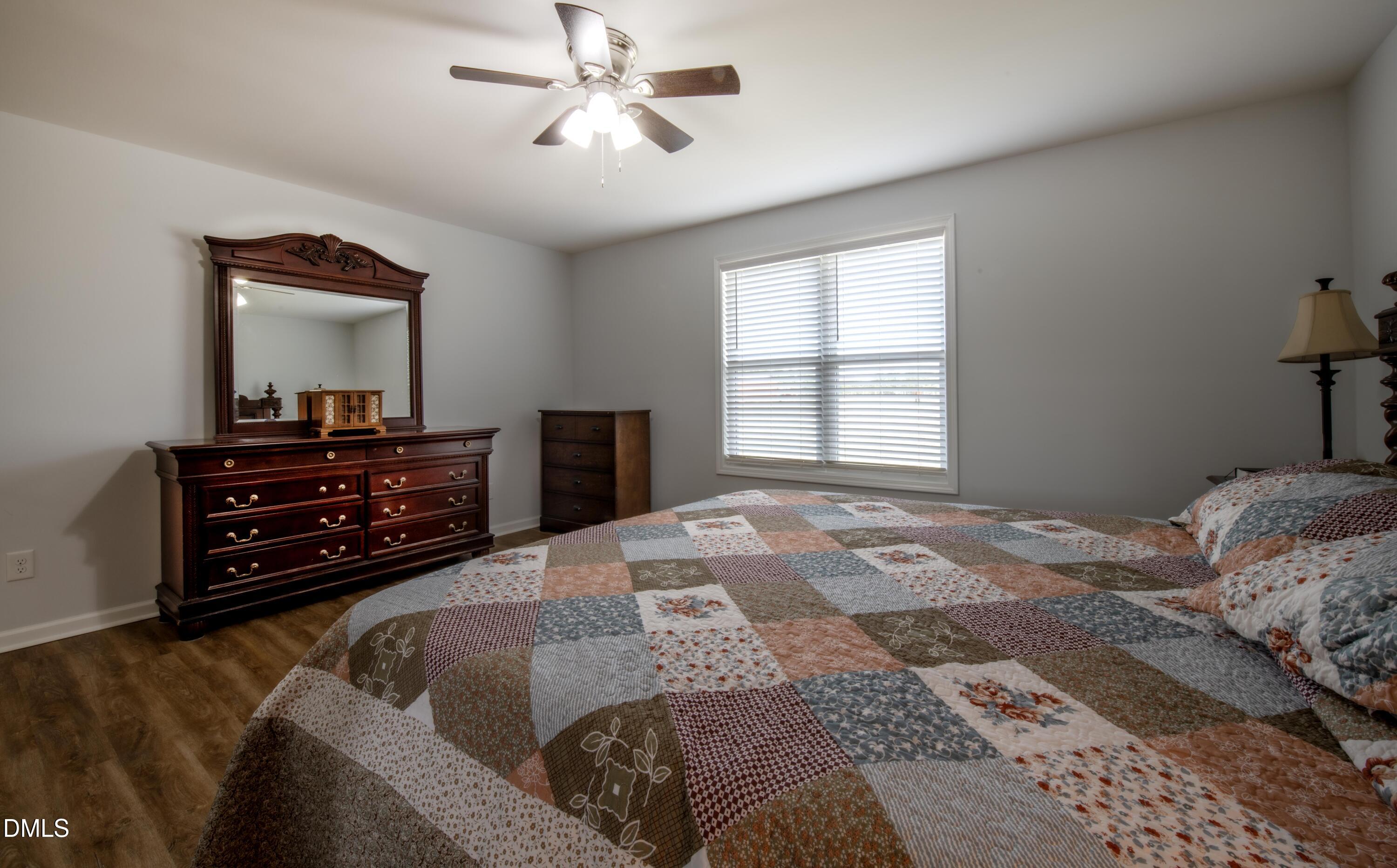 130 Hardy Road Wendell, NC 27591 - Photo 18 of 34 a bedroom with a bed and dresser with mirror