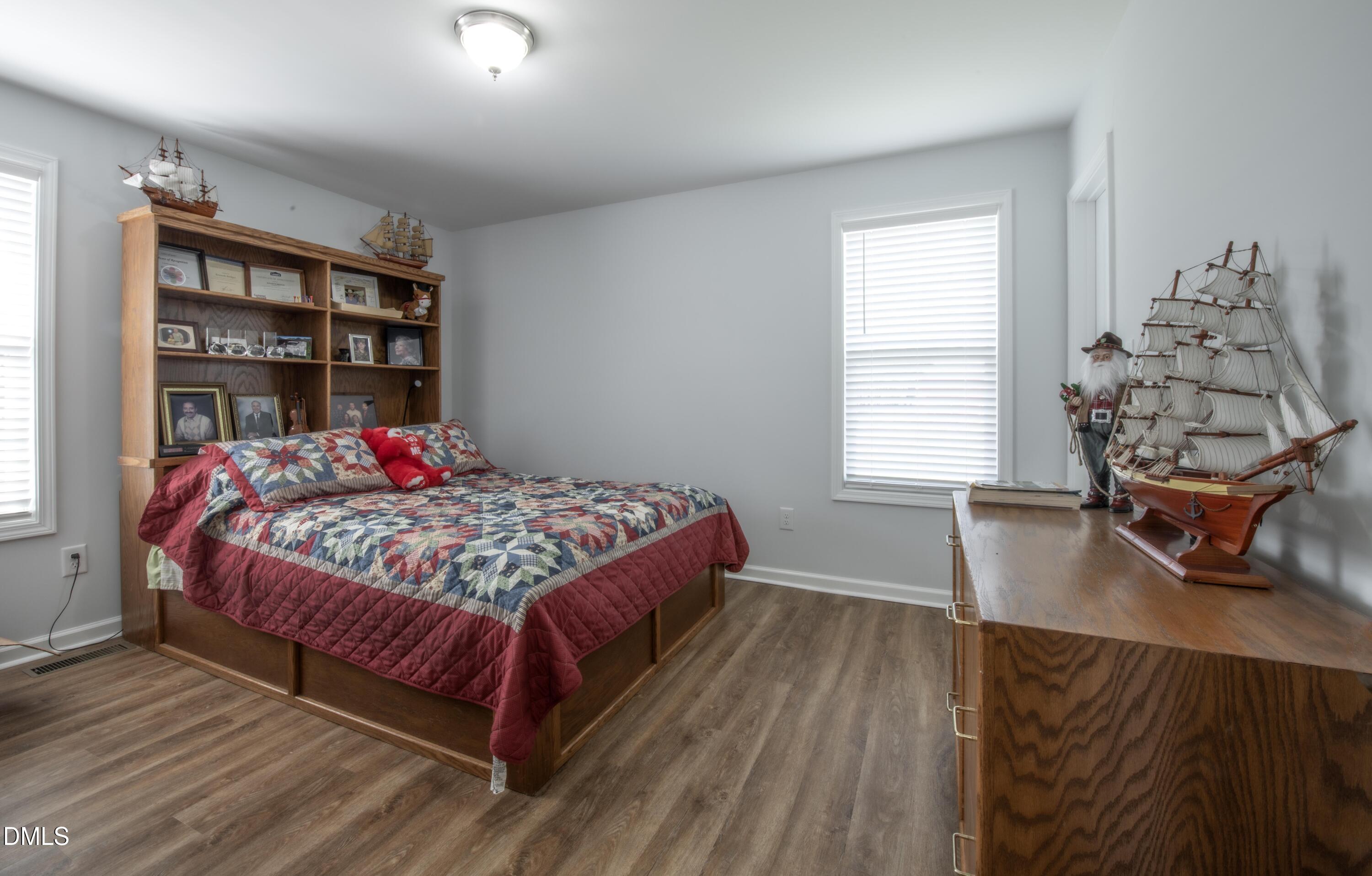 130 Hardy Road Wendell, NC 27591 - Photo 23 of 34 a bedroom with a bed and a book shelf