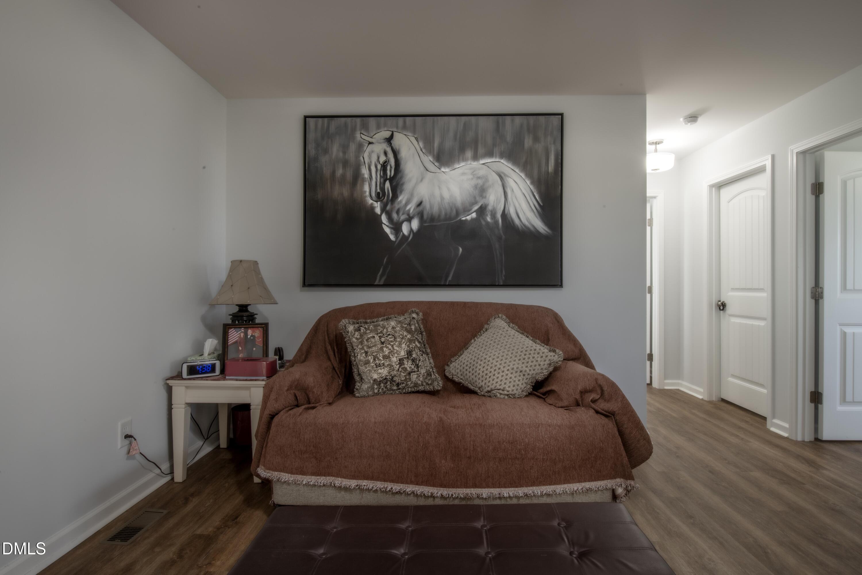 130 Hardy Road Wendell, NC 27591 - Photo 26 of 34 a bedroom with a bed and wooden floor