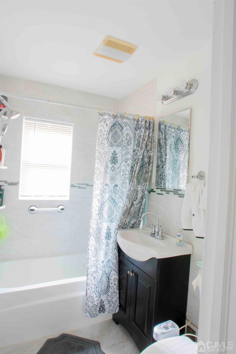 2 High Point Road East Brunswick, NJ 08816 - Photo 14 of 36 a bathroom with a sink and a mirror