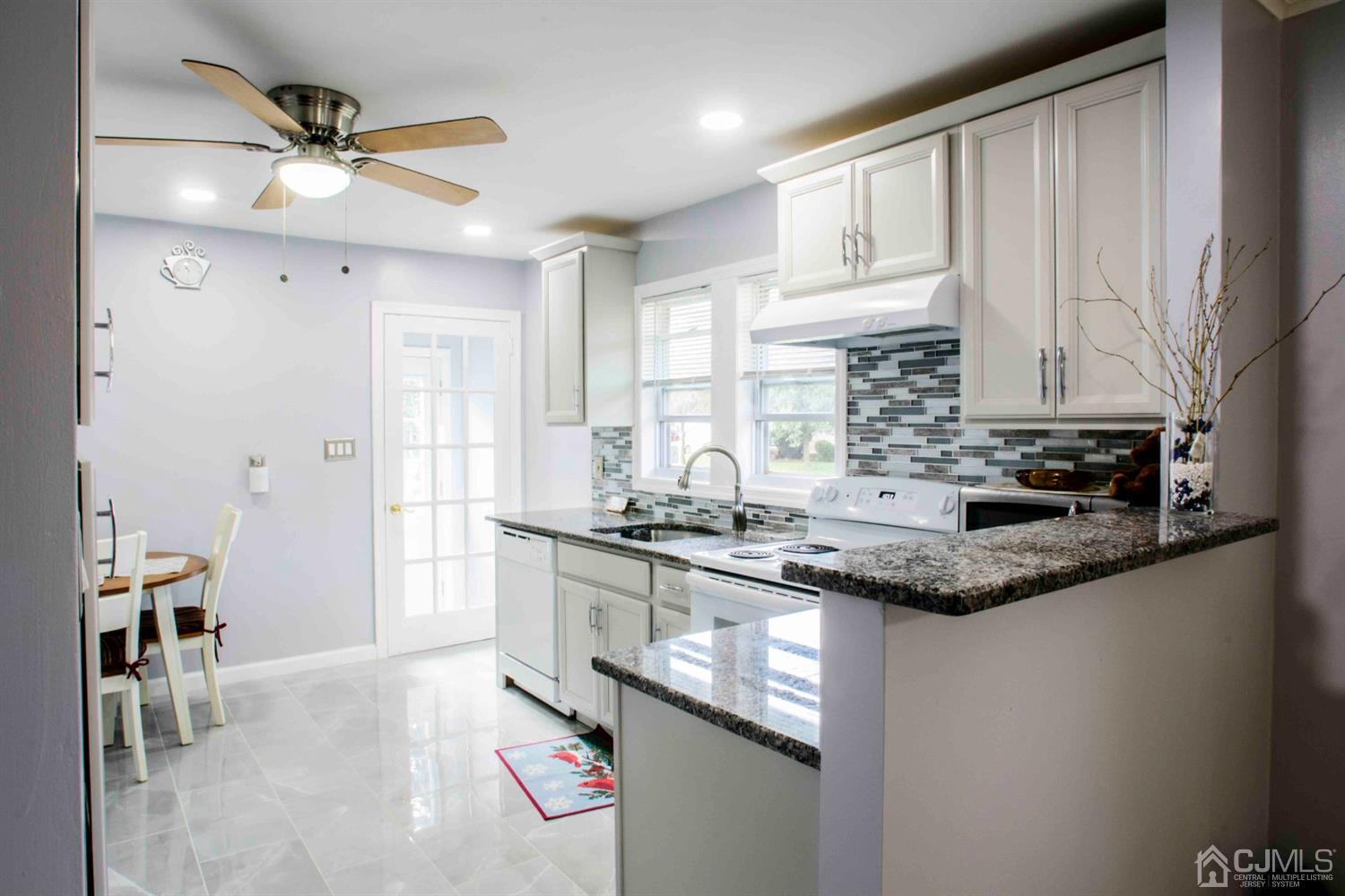 2 High Point Road East Brunswick, NJ 08816 - Photo 4 of 36 a kitchen with stainless steel appliances granite countertop a sink a stove and a refrigerator