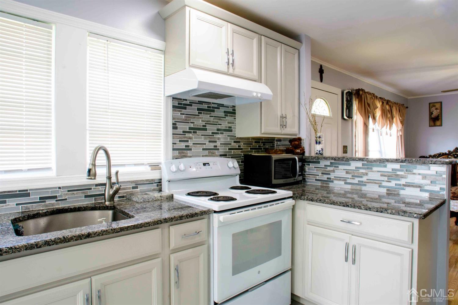 2 High Point Road East Brunswick, NJ 08816 - Photo 6 of 36 a kitchen with granite countertop a sink stove and cabinets
