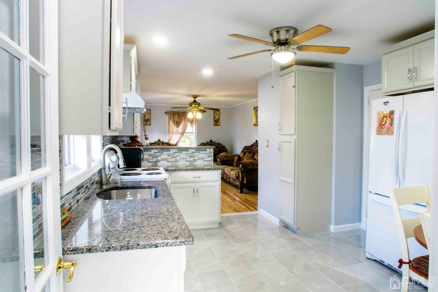 2 High Point Road East Brunswick, NJ 08816 - Photo 8 of 36 a kitchen with kitchen island a counter top space appliances and a view of living room