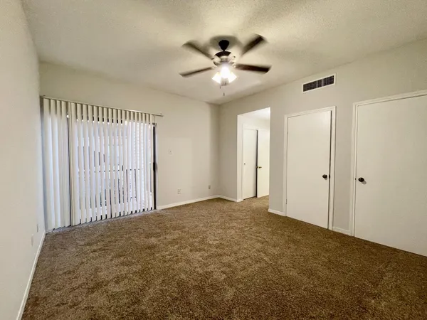 a view of a livingroom with a ceiling fan and window
