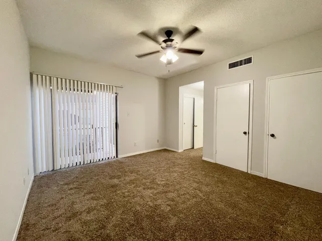 a view of a livingroom with a ceiling fan and window