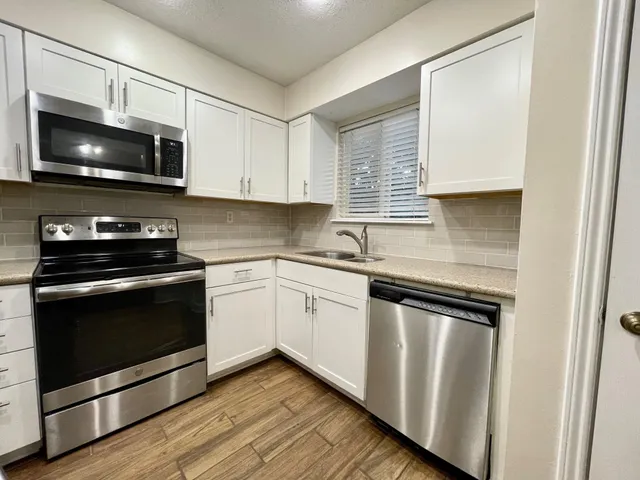 a kitchen with a sink stove and microwave