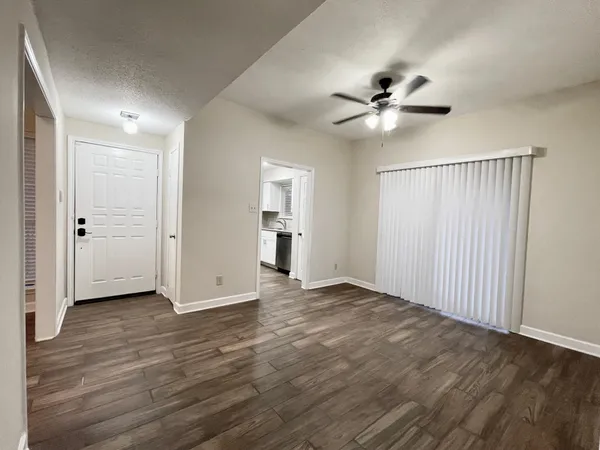 a view of an empty room with a ceiling fan