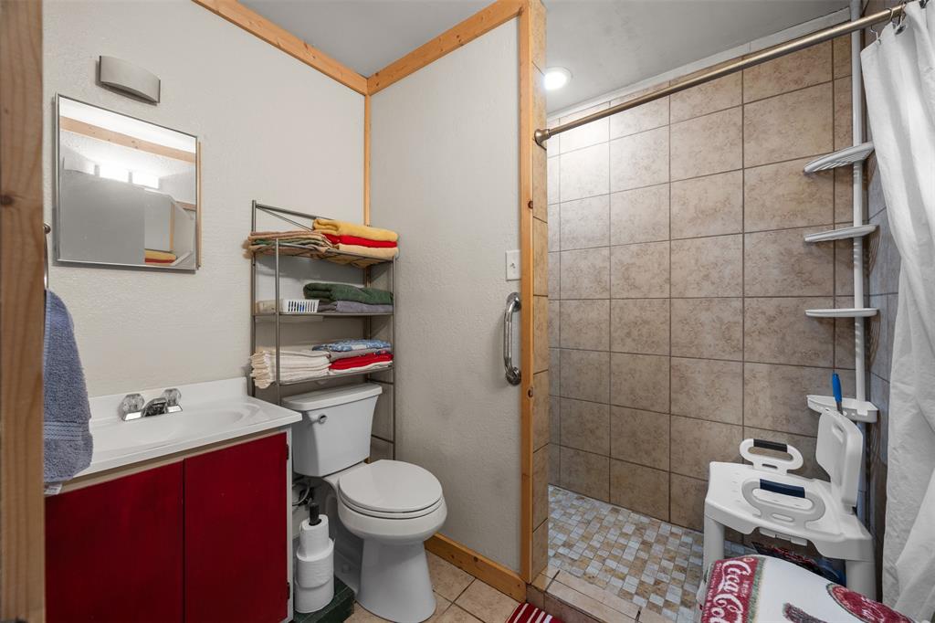 153 Center Loop Whitney, TX 76692 - Photo 12 of 21 a bathroom with a toilet and a shower