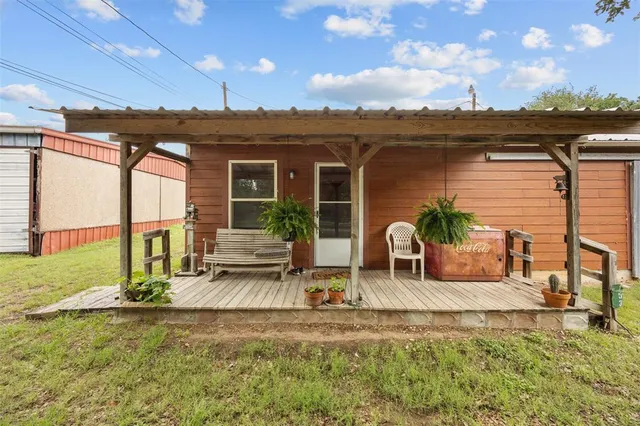 a view of a house with backyard porch and sitting area