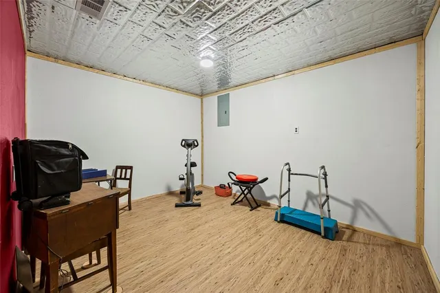 a view of a room with wooden floor and lounge chair