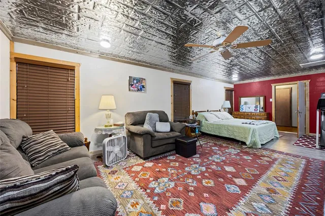 a bedroom with furniture and wooden floor