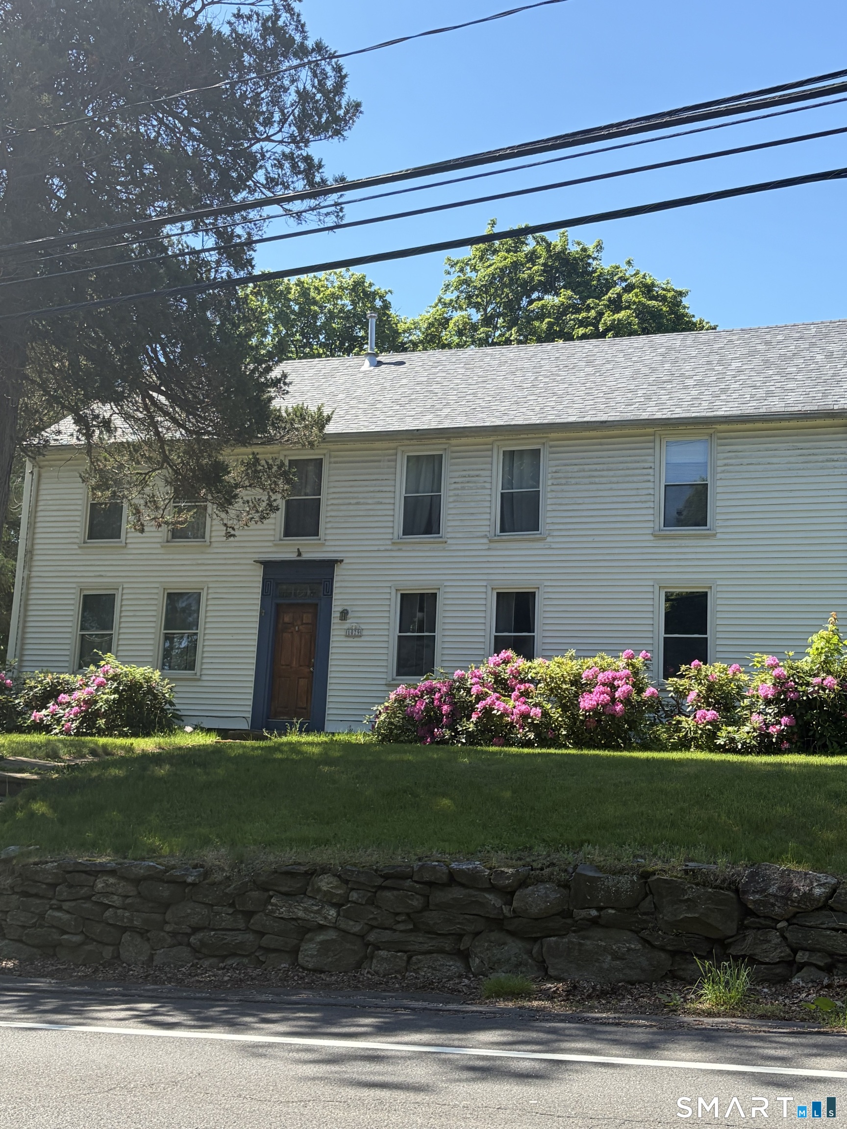 1079 Main Street Coventry, CT 06238 - Photo 2 of 19 a front view of a house with a yard