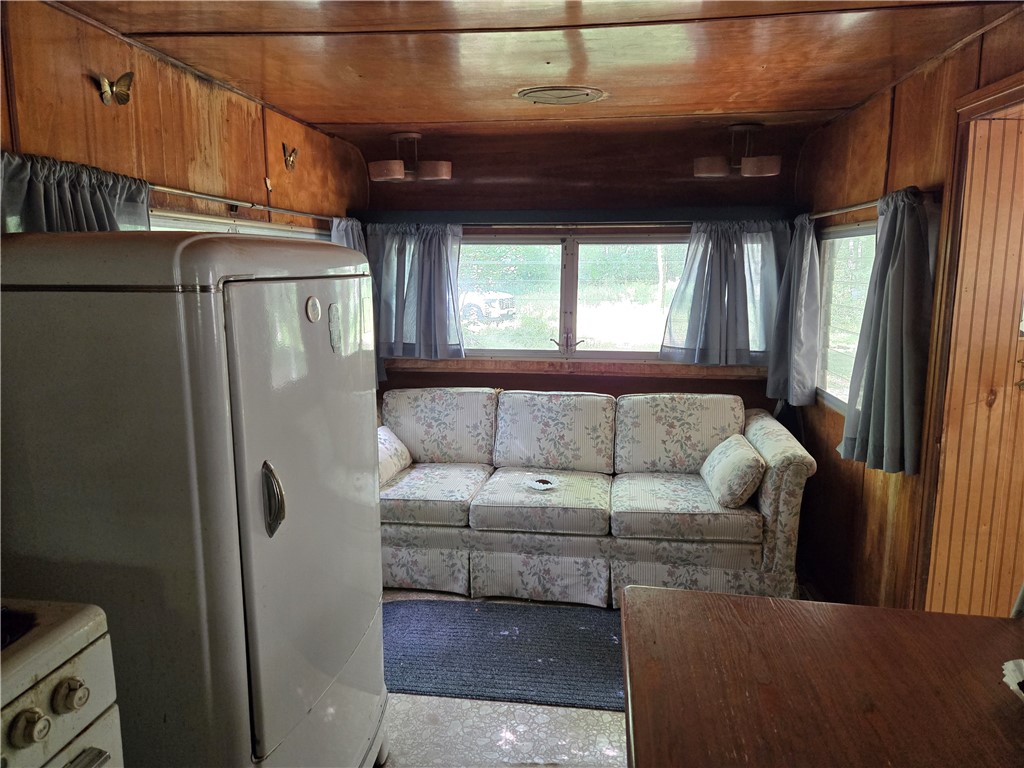 4175 Pre Emption Road Tyrone, NY 14891 - Photo 15 of 19 featuring a sofa and large windows that bring in n