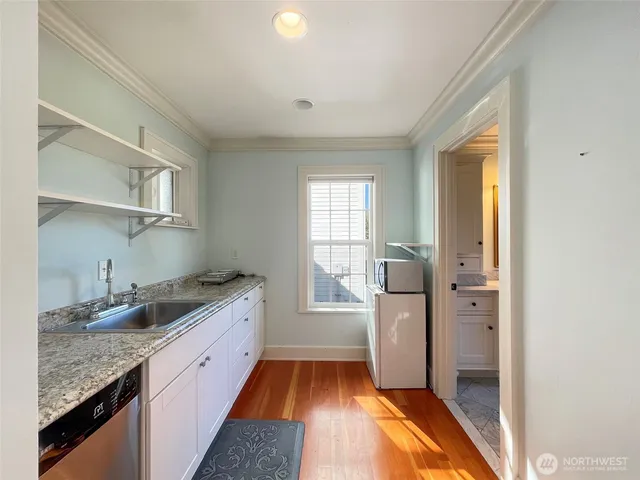 a kitchen with granite countertop cabinets and window