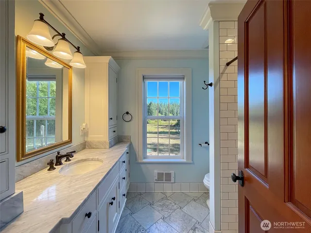 a bathroom with a shower toilet and sink