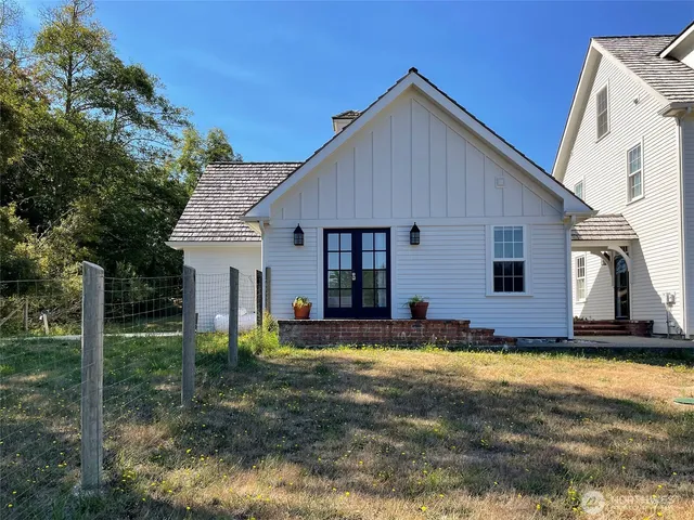 a view of a house with yard and sitting area