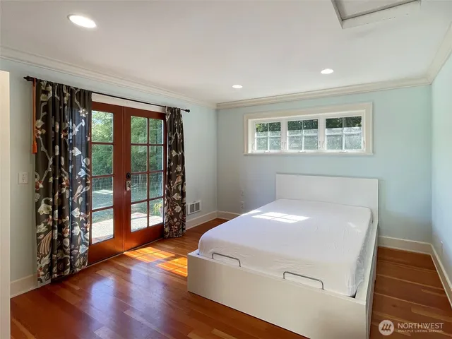 a bedroom with a bed and window