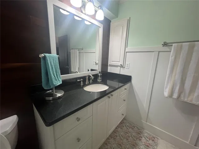 a bathroom with a sink a mirror and a toilet