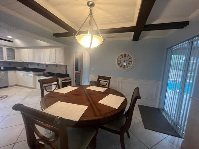 a view of a dining room with furniture and window