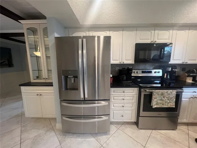 a kitchen with a refrigerator and microwave
