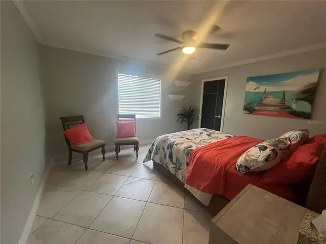 a bedroom with a bed and chair