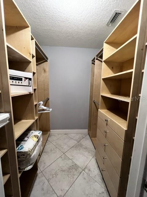 681 Verona Street Port Charlotte, FL 33948 - Photo 22 of 40 a view of walk in closet with clothes and shoes
