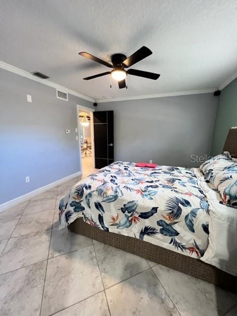681 Verona Street Port Charlotte, FL 33948 - Photo 23 of 40 a bedroom with a bed and a ceiling fan