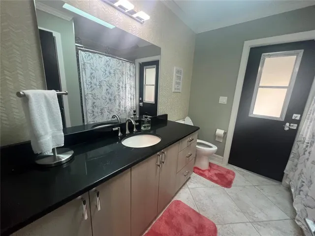a bathroom with a sink vanity and mirror