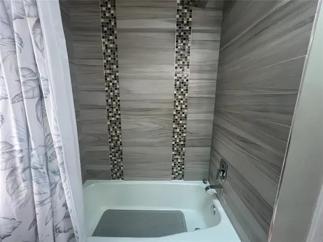 a bathroom with a bathtub and shower