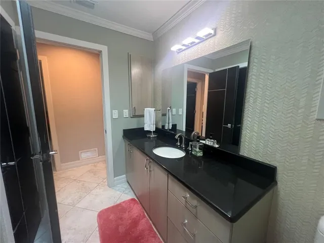 a bathroom with a sink a toilet and a mirror