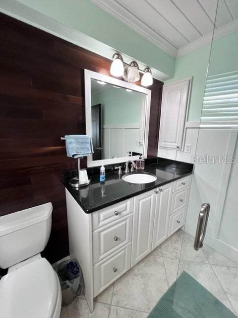 681 Verona Street Port Charlotte, FL 33948 - Photo 28 of 40 a bathroom with a granite countertop toilet sink and mirror
