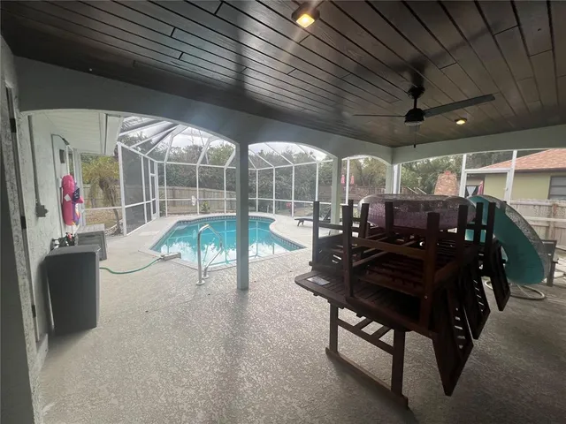 a living room with lots of chairs and a chandelier
