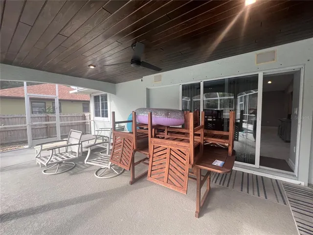 a view of swimming pool with seating area and furniture