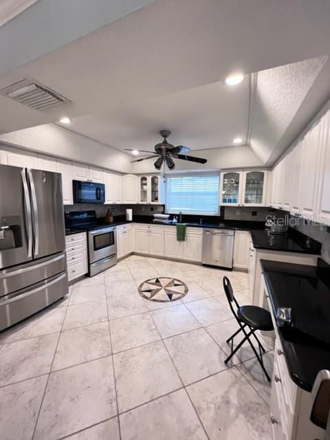 681 Verona Street Port Charlotte, FL 33948 - Photo 4 of 40 a kitchen with stainless steel appliances kitchen island granite countertop a sink and cabinets