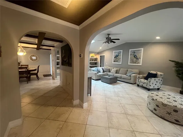 a living room with furniture and a mirror