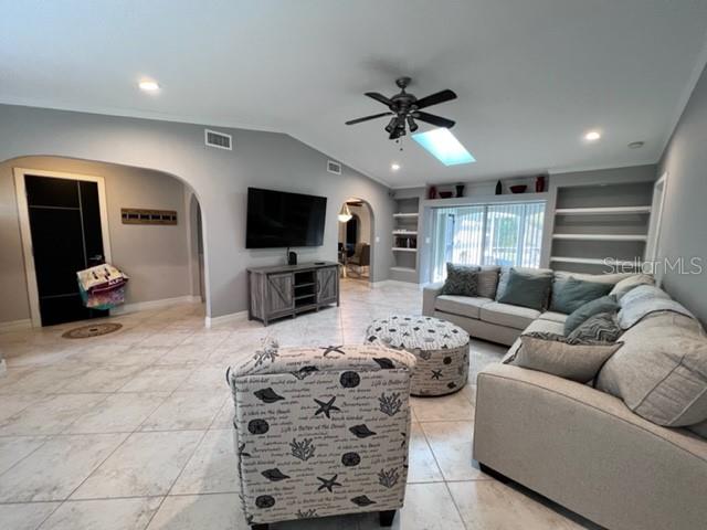 681 Verona Street Port Charlotte, FL 33948 - Photo 9 of 40 a living room with furniture a flat screen tv and a chandelier