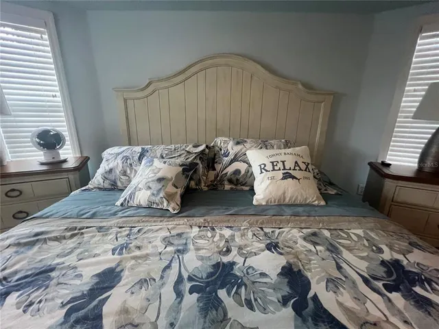 a bedroom with a bed and a window