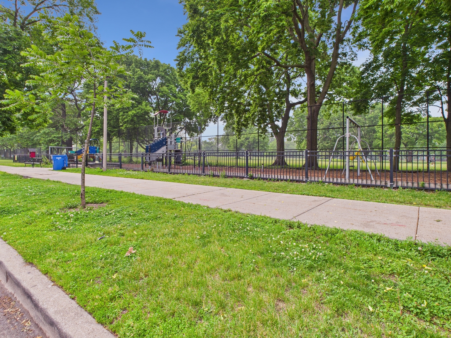 1729 East 67th Street, Unit 2E Chicago, IL 60649 - Photo 14 of 18 a view of a park with swings and slides