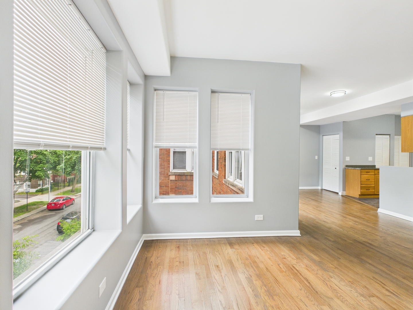 1729 East 67th Street, Unit 2E Chicago, IL 60649 - Photo 5 of 18 wooden floor in an empty room with a window
