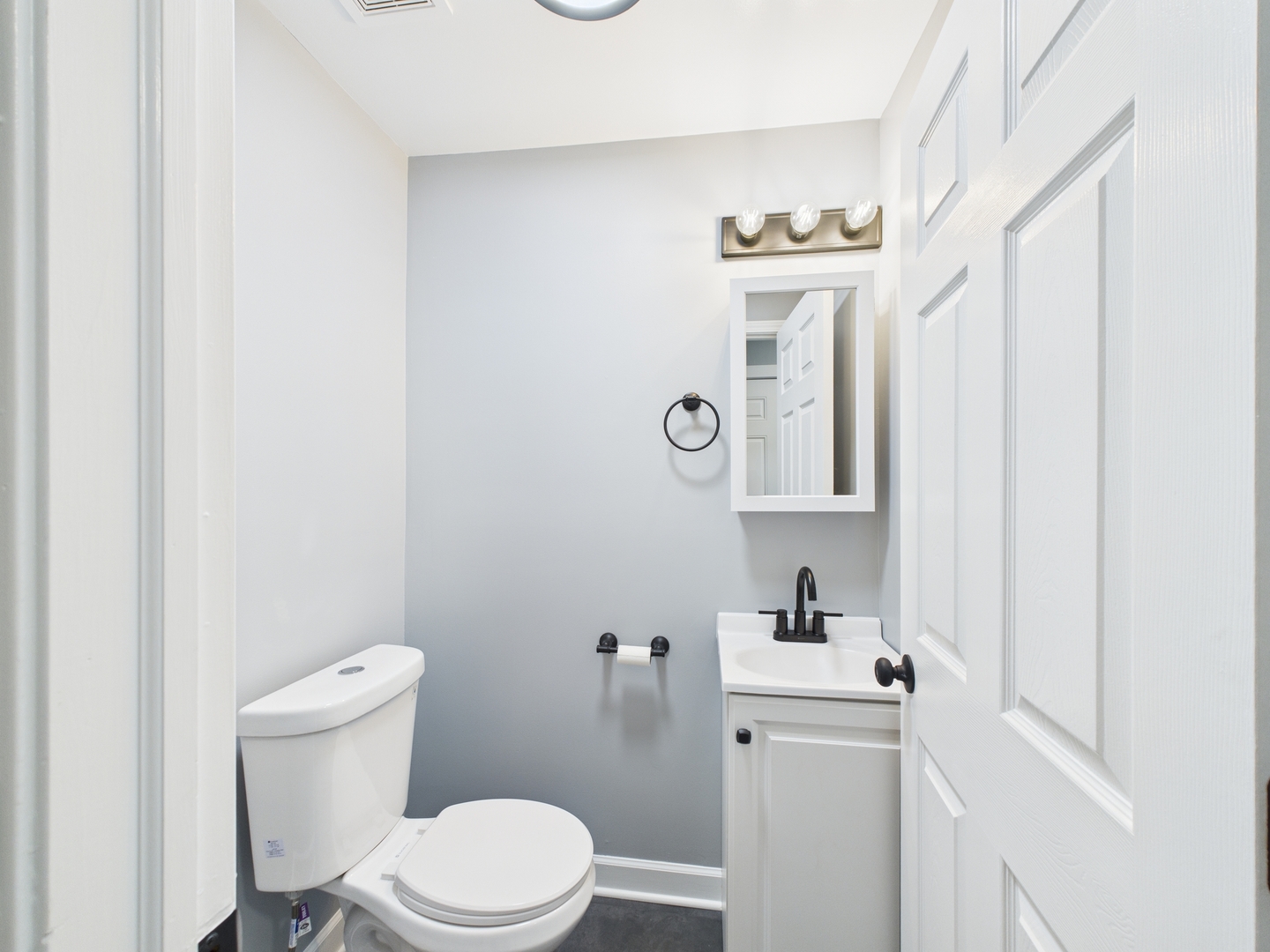 1729 East 67th Street, Unit 2E Chicago, IL 60649 - Photo 9 of 18 a bathroom with a sink a toilet and a mirror