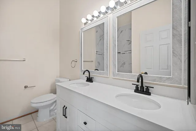 a bathroom with a sink a toilet and a mirror