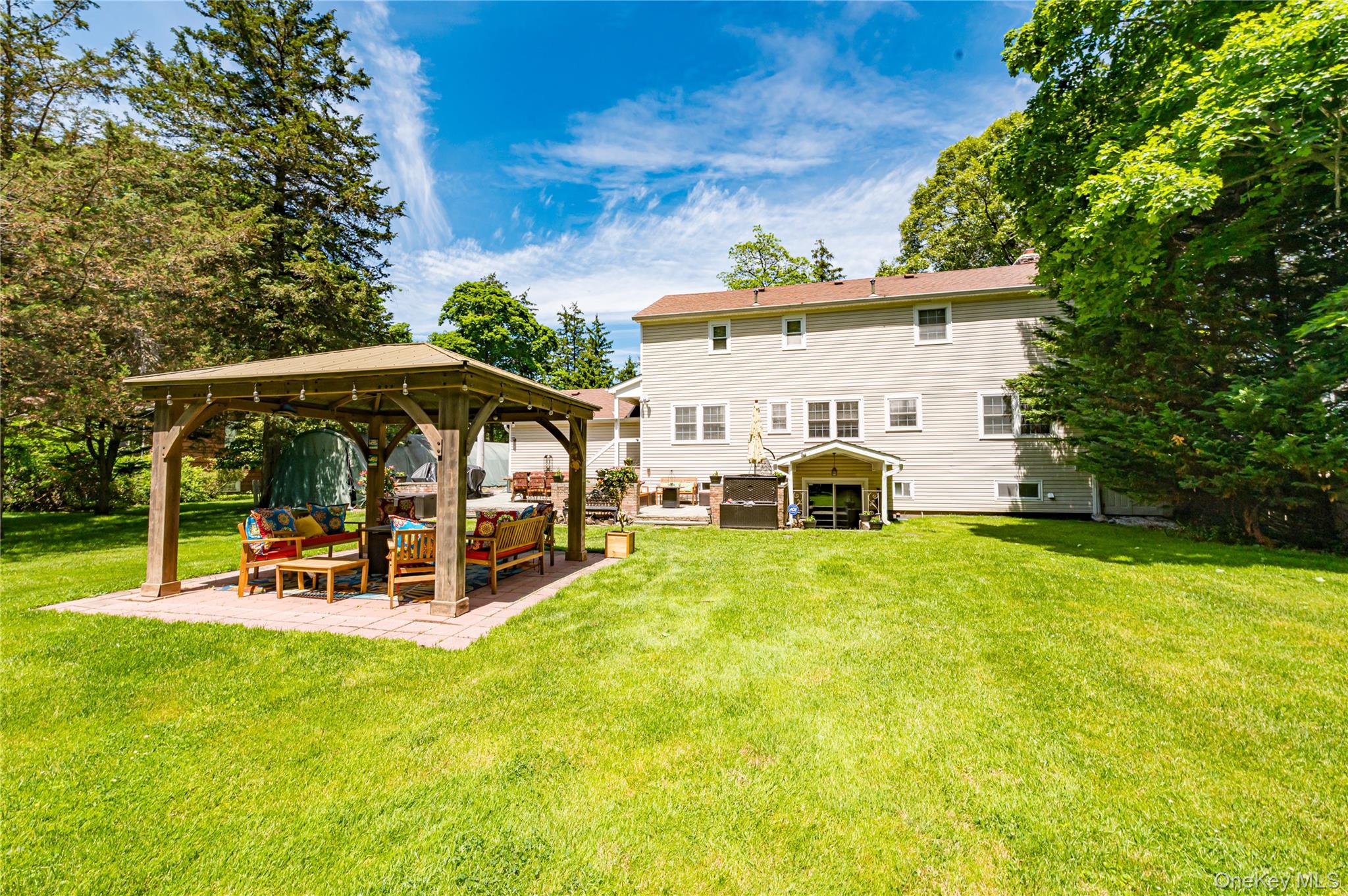 3 Thompson Hill Road St. James, NY 11780 - Photo 33 of 34 a view of a patio with a table and chairs under an umbrella