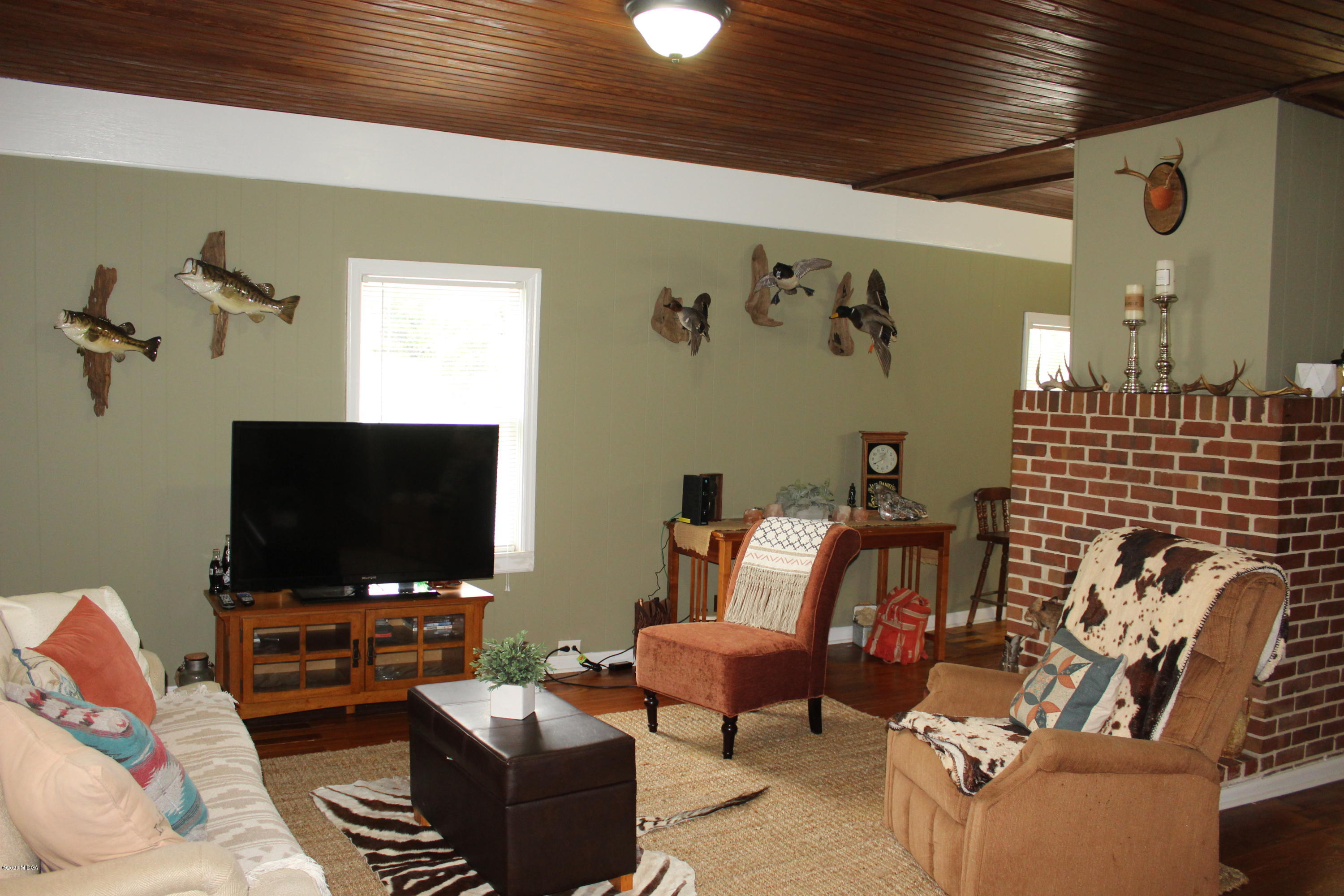 35 Gose Road Forsyth, GA 31029 - Photo 3 of 16 a living room with furniture and a flat screen tv