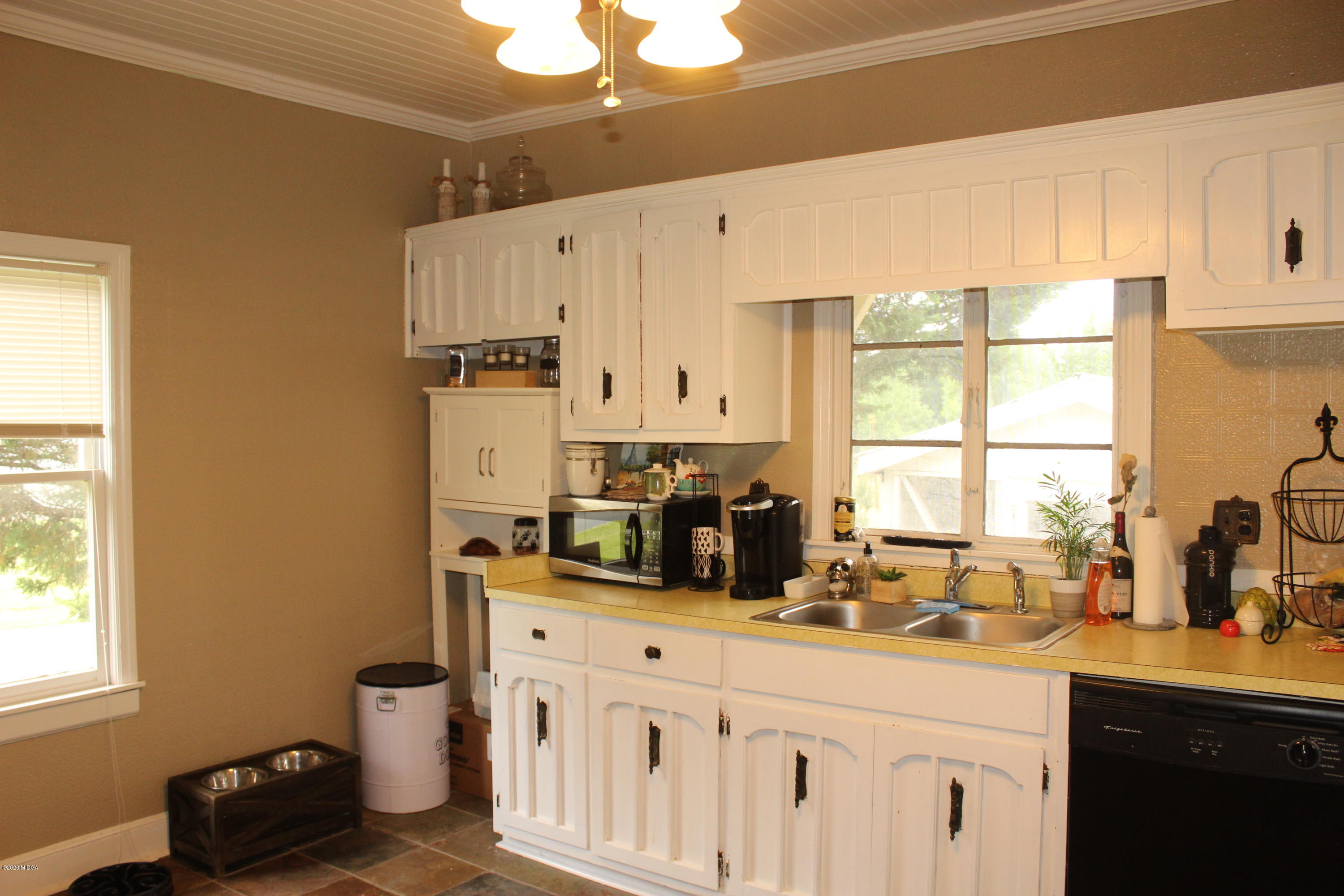 35 Gose Road Forsyth, GA 31029 - Photo 6 of 16 a kitchen with granite countertop a sink cabinets stainless steel appliances and a window