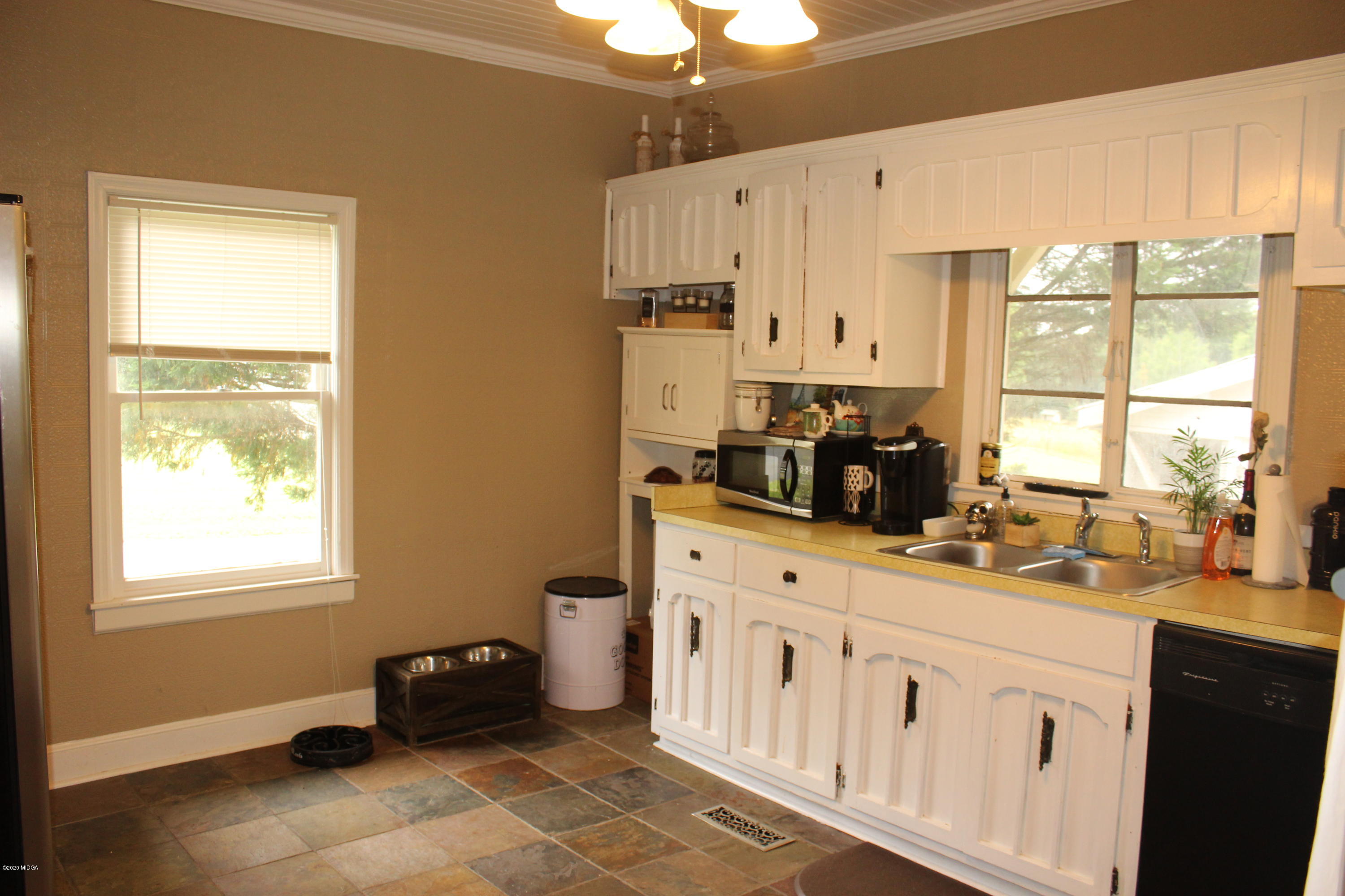 35 Gose Road Forsyth, GA 31029 - Photo 8 of 16 a kitchen with granite countertop a sink cabinets and window